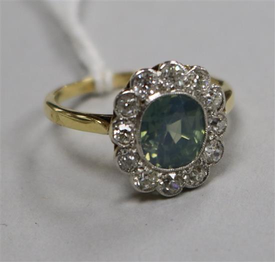 An 18ct gold, diamond and pale blue/green zircon set oval cluster ring, size P.